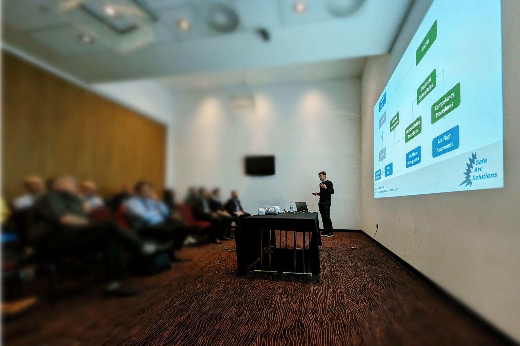 Safe Arc Solutions presenting a slide on managing arc flash to a room of IET members in Aberdeen