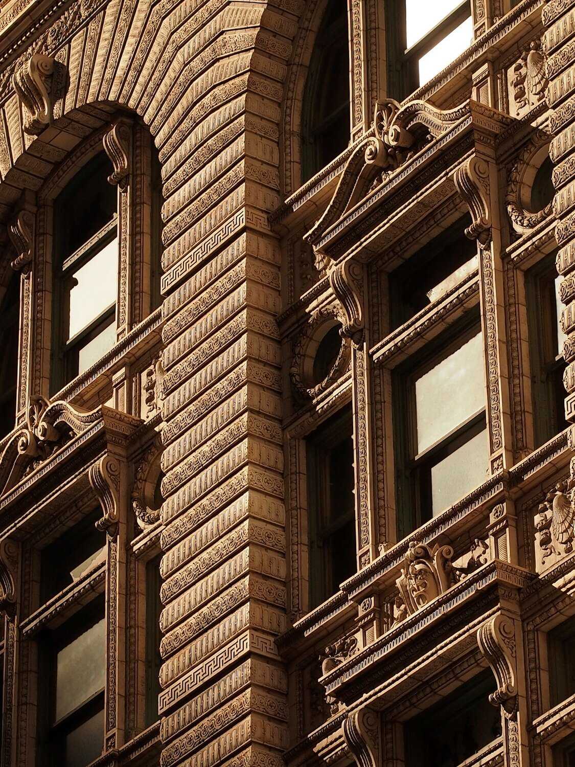 Exterior of large stone building in city downtown