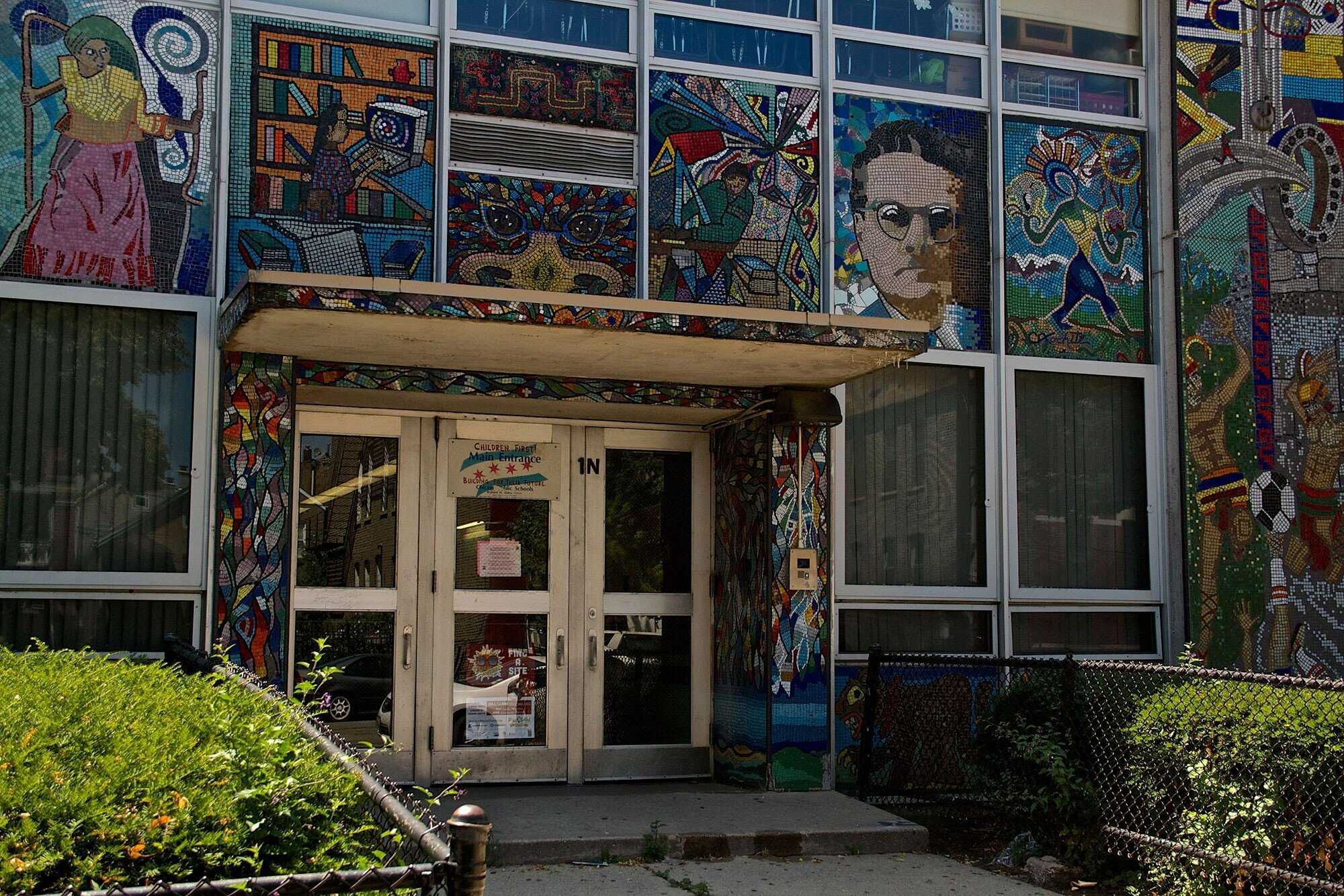 Exterior of school entrance with mosaic art of sev