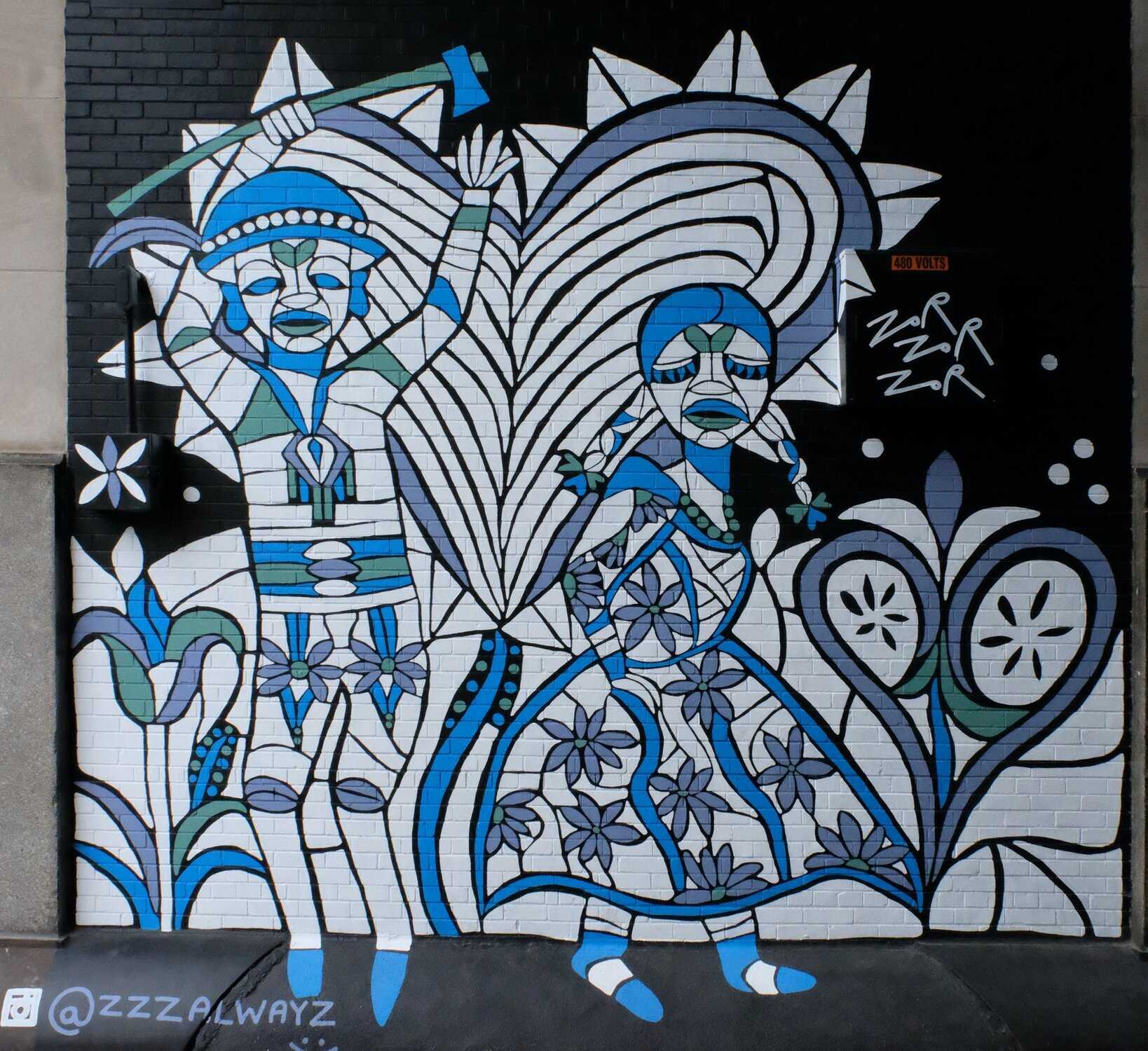 Blue and white mural of abstract man and woman