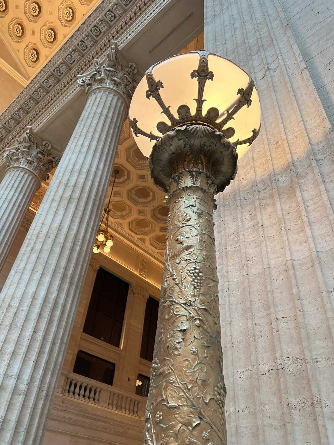 Photo of a golden light post inside of Union Station with detailed ornamentation