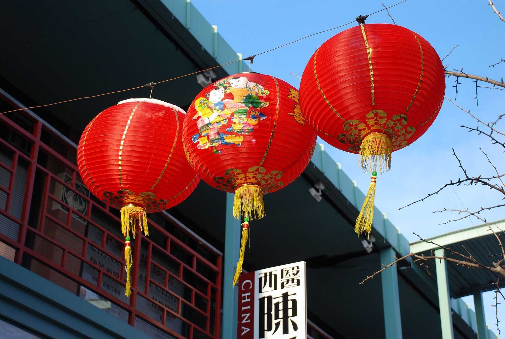 A photo of chinese lanterns strung across Chinatown Square.