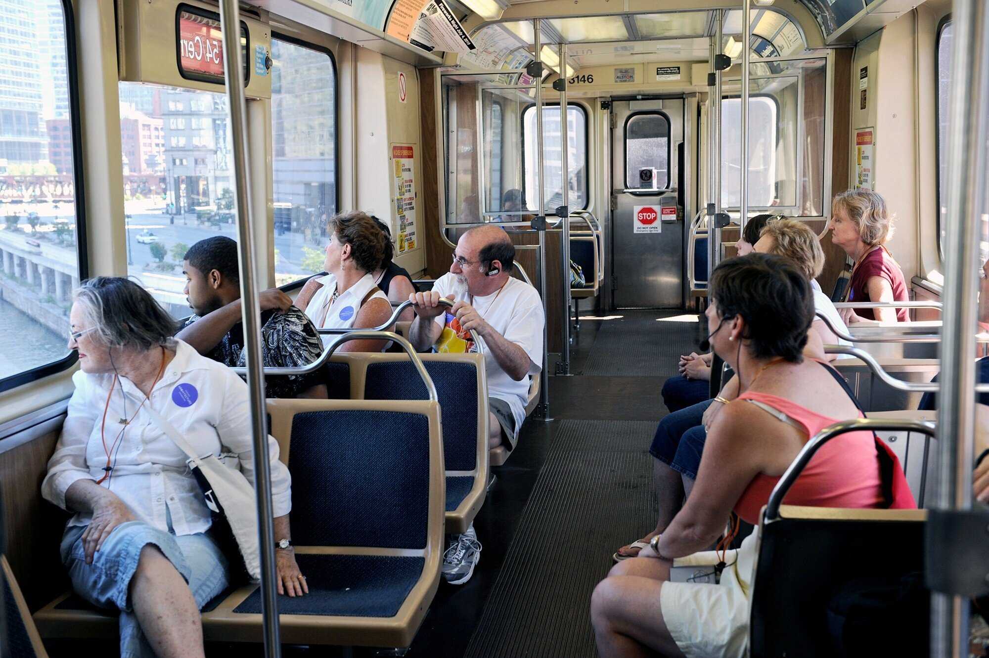 Group of people sitting inside Chicago CTA train car