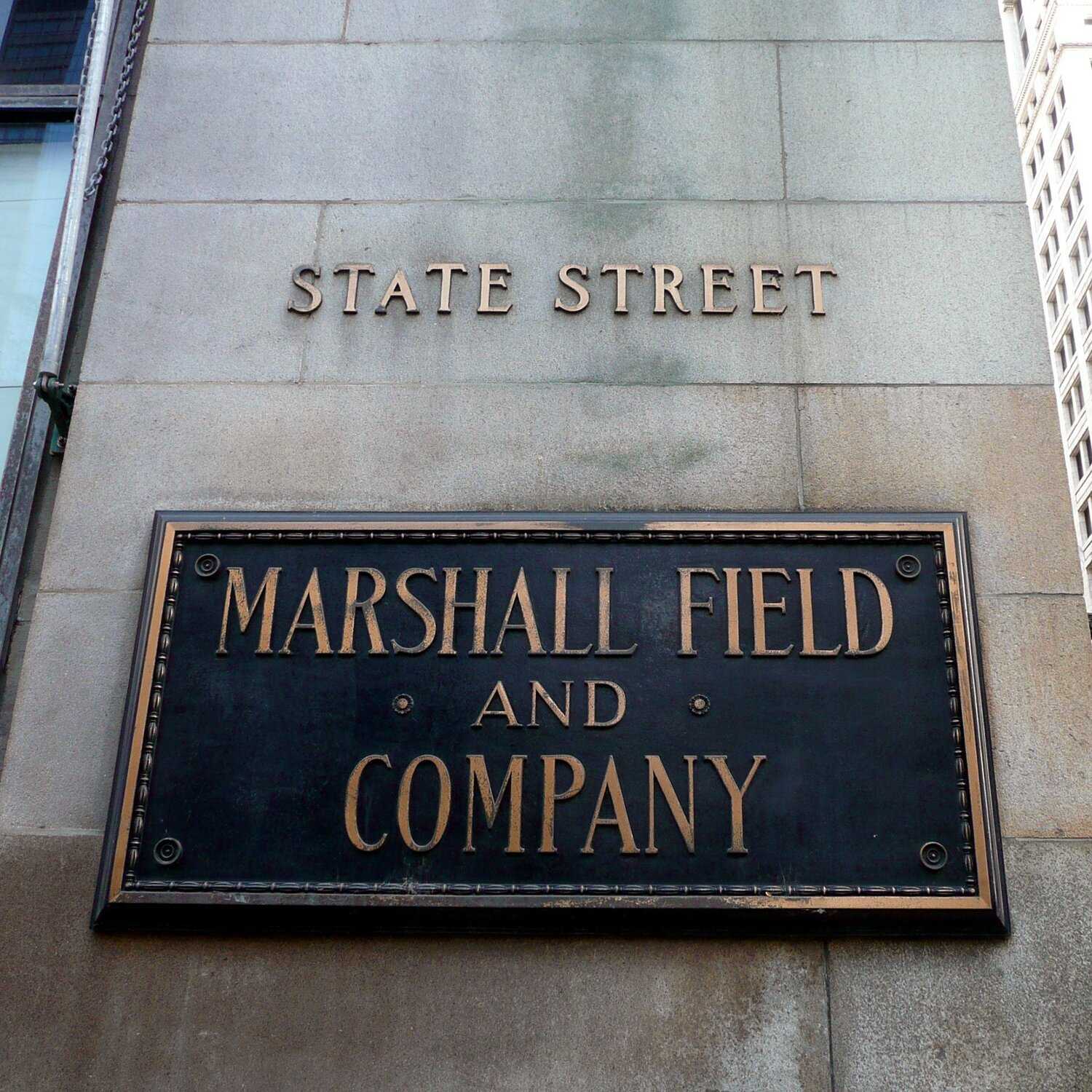 Store plaque on exterior of stone building