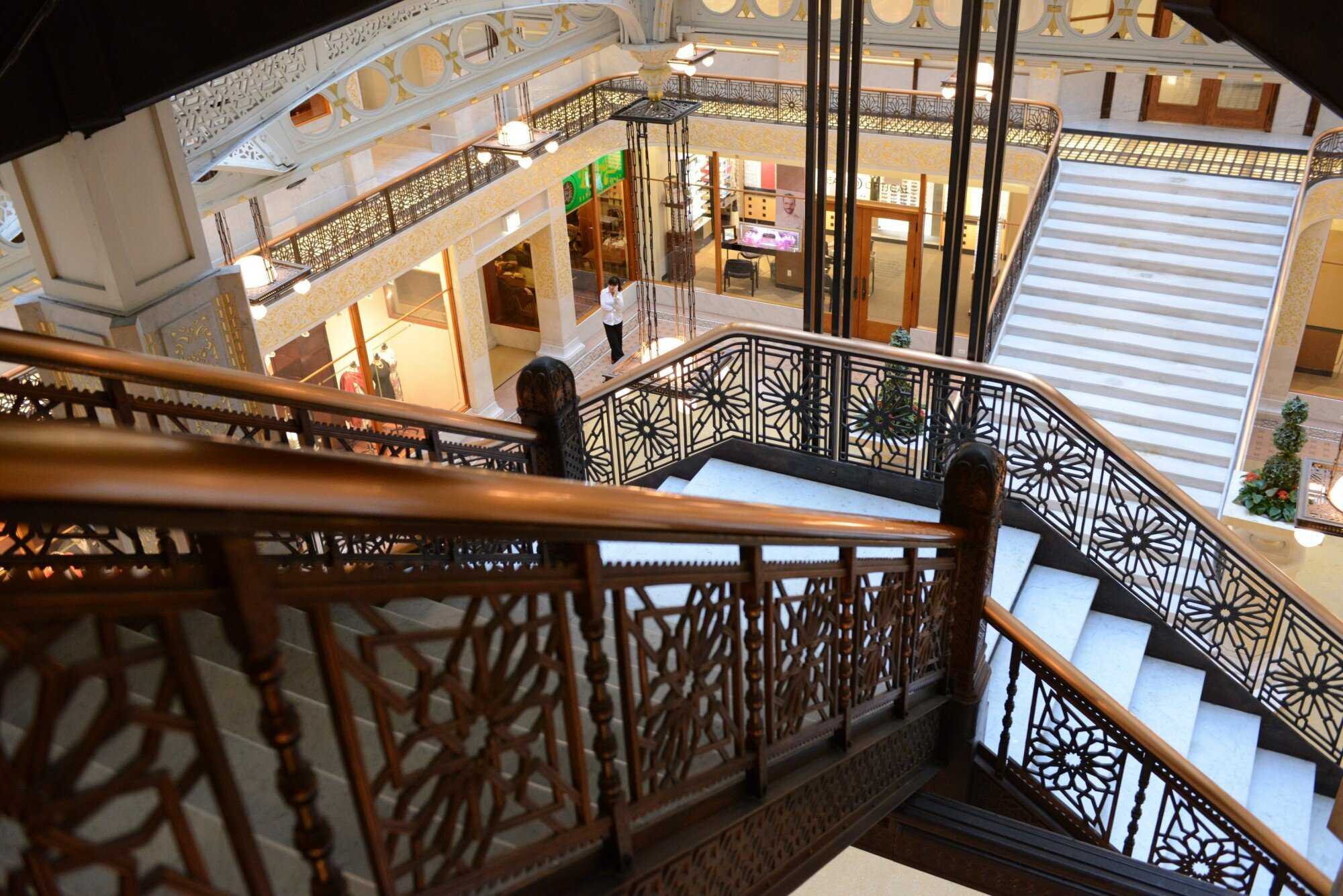 view looking down a staircase with black ornate railings