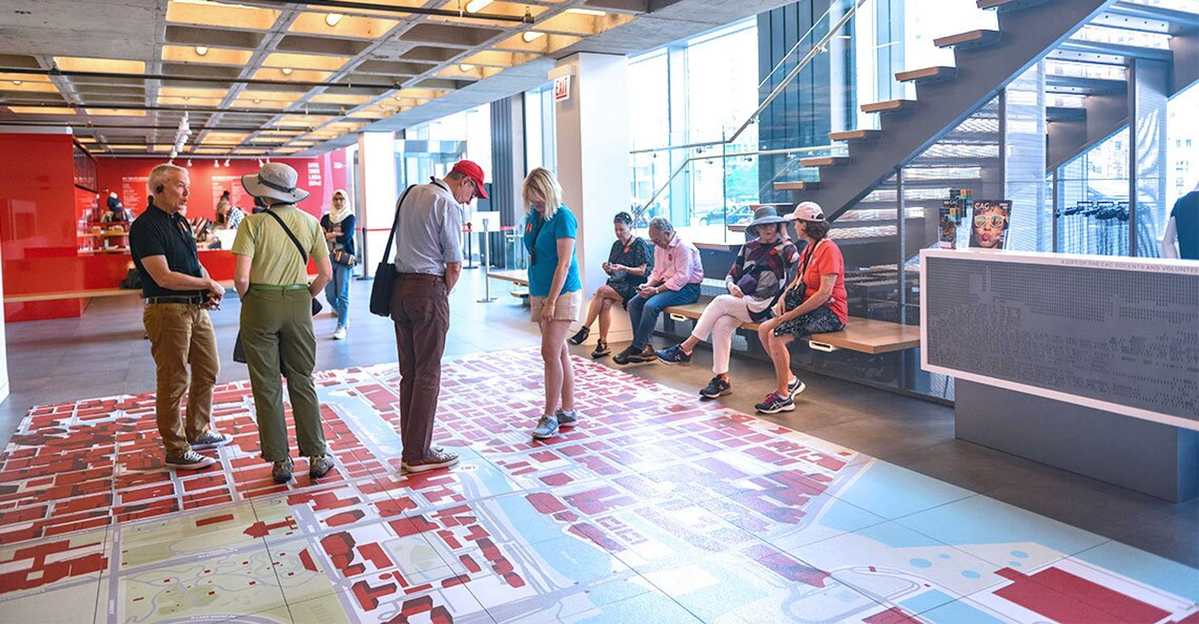 Center lobby, tourists standing around and observing the center