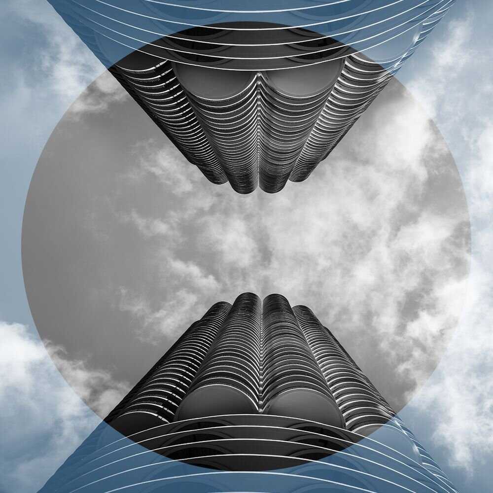 Black and white shot of looking up at two skyscrapers