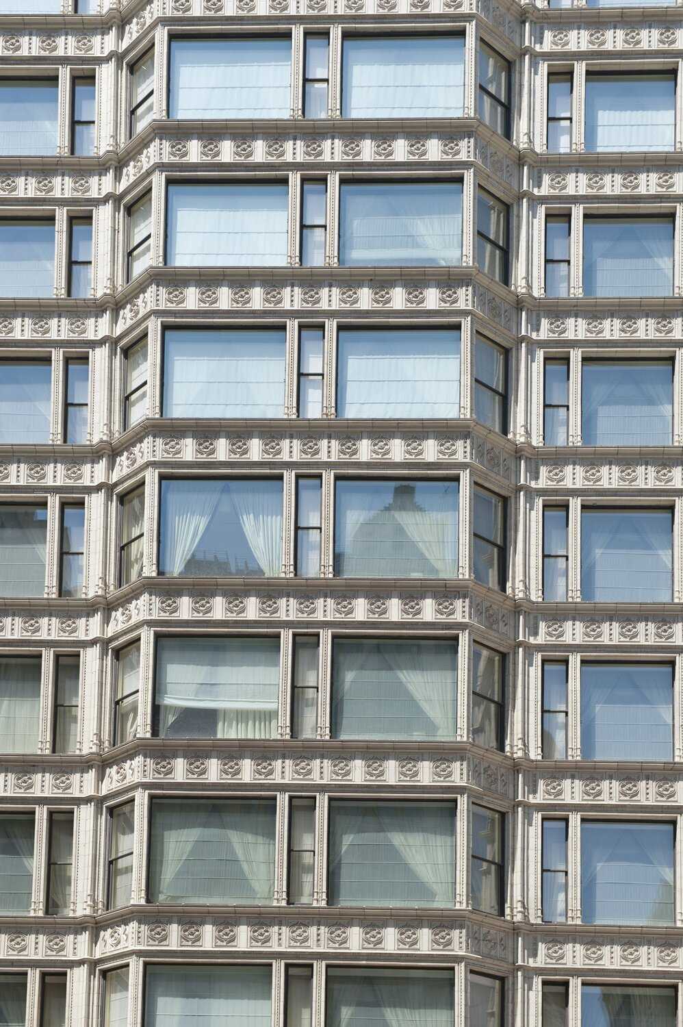 Exterior of white building with large windows