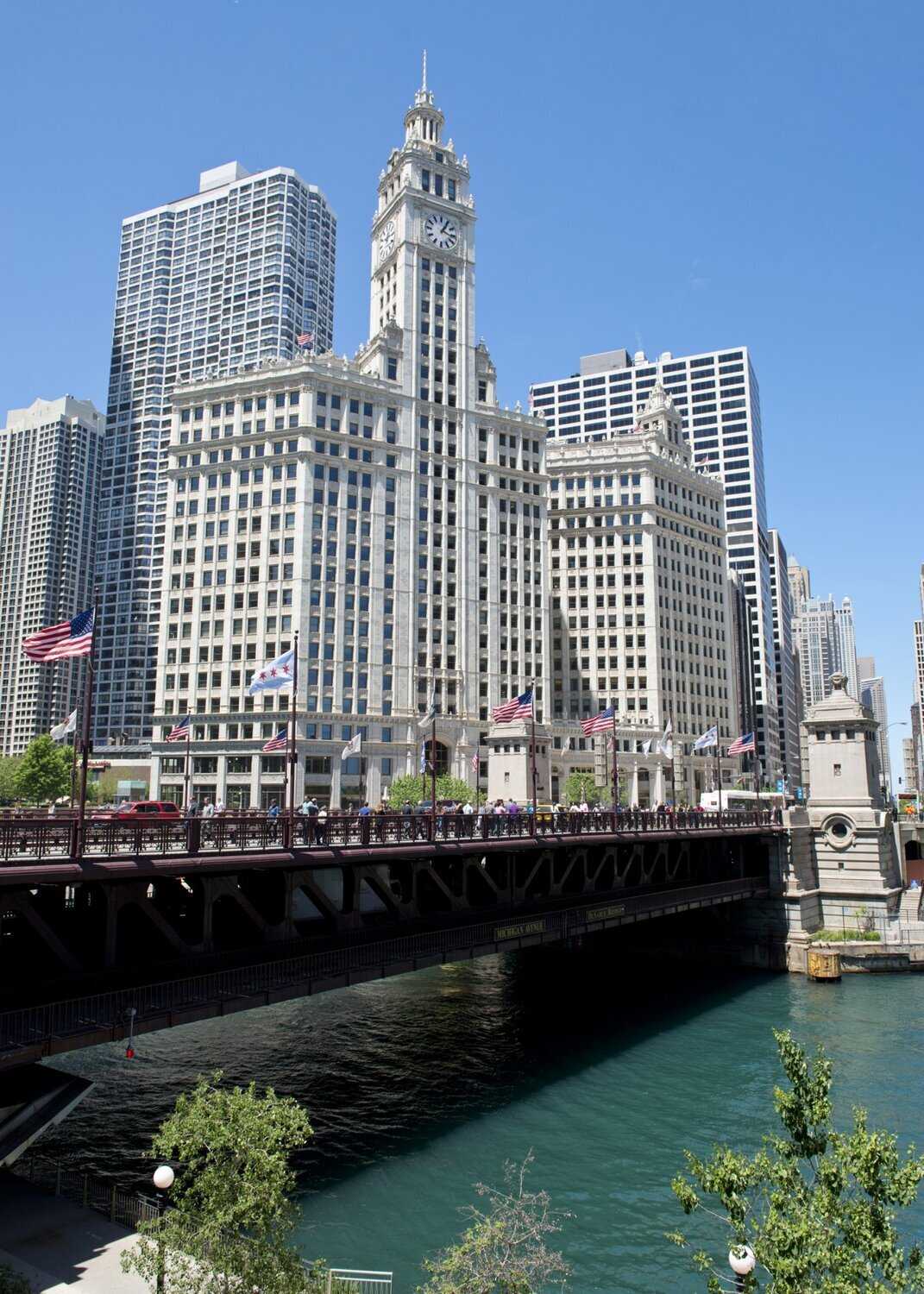 A photo of the Wrigley building as seen from across the river.