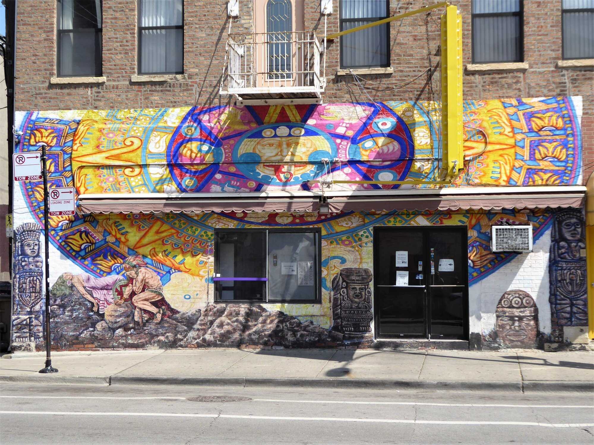 Brightly colored mural on the side of a brick building