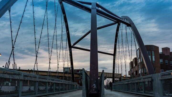 Evening view of pedestrian bridge with night sky. 