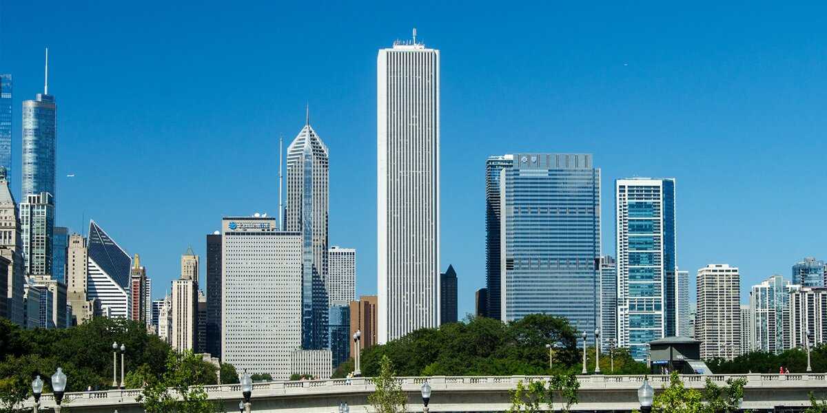 A line of tall skyscrapers amidst a blue sky