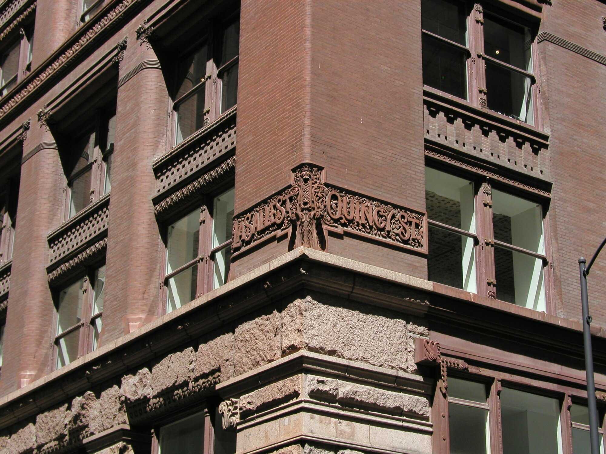 Corner of building with ornate lettering of street names