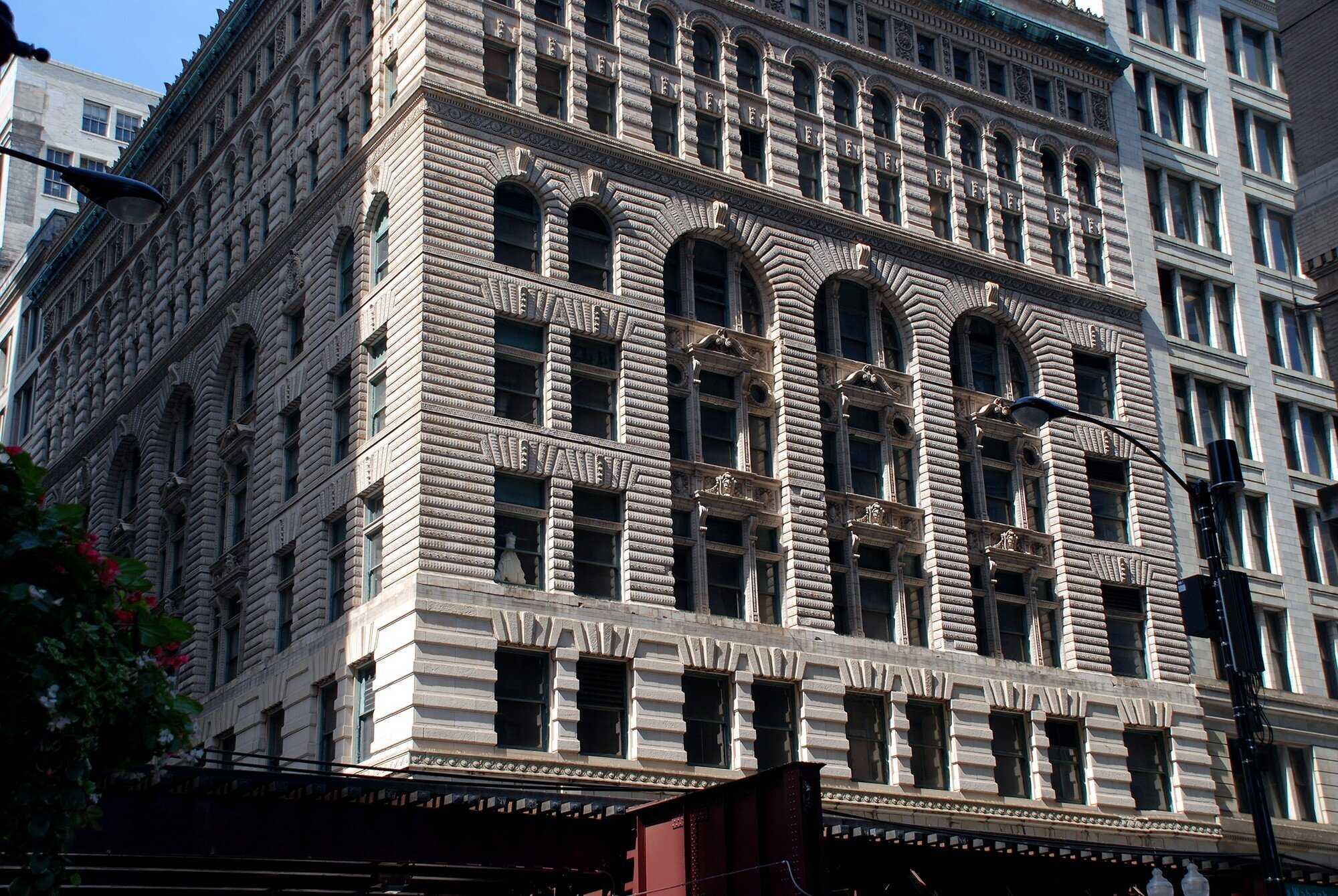 Exterior of large stone building in city downtown