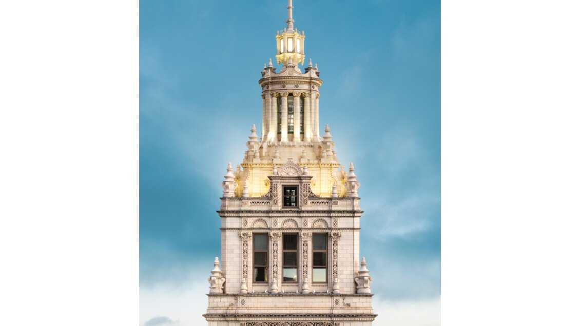 Aerial shot of the top of an ornate building with a clock