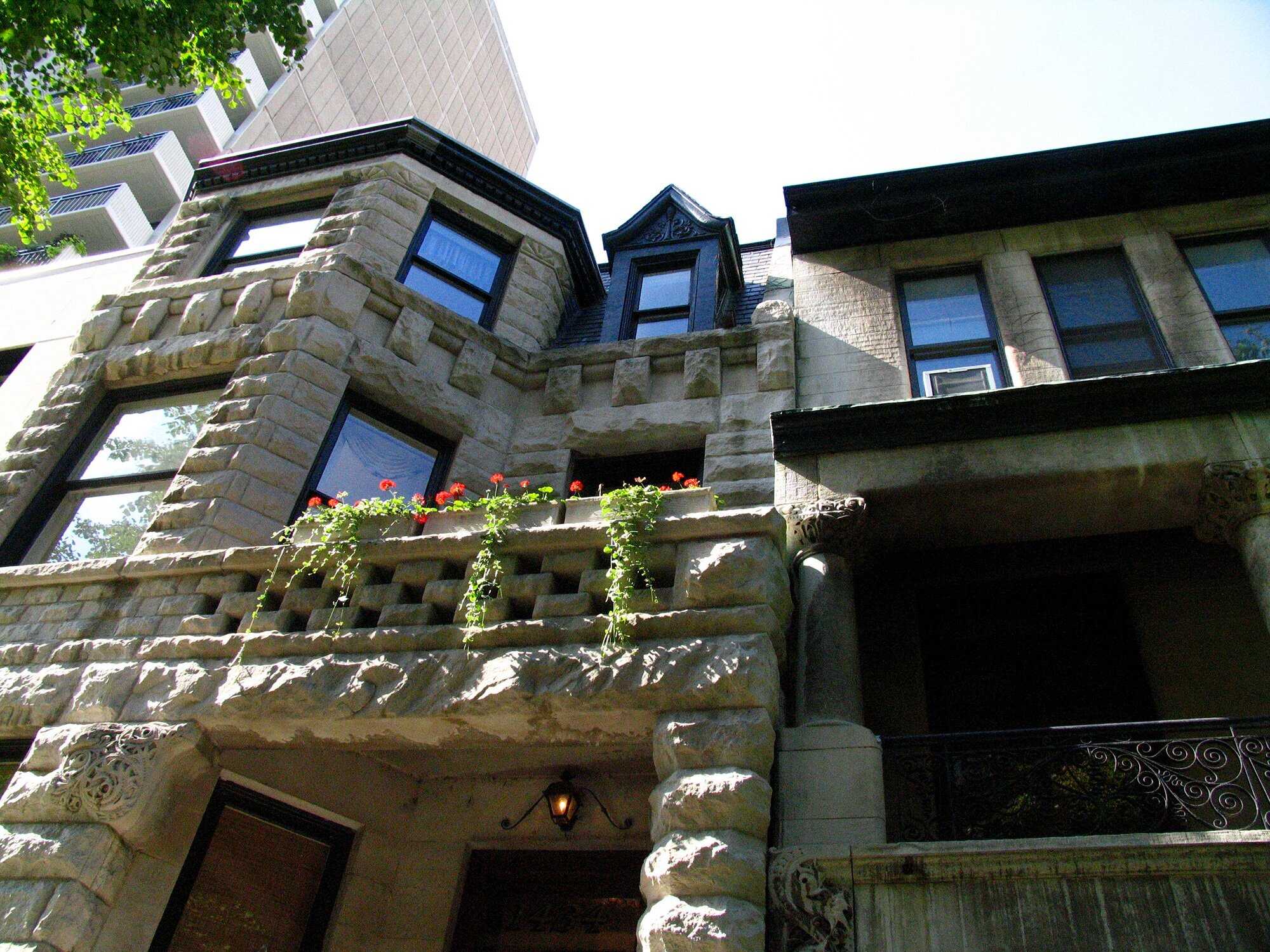 Photo of 1432 Astor Street looking up at a balcony from the sidewalk