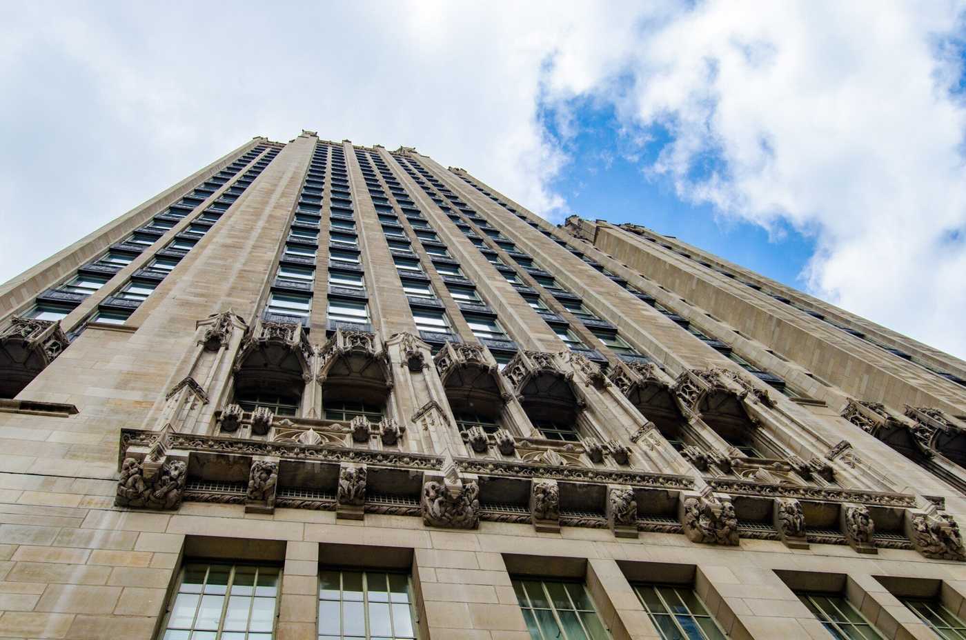 Looking up at large beige building with many windows