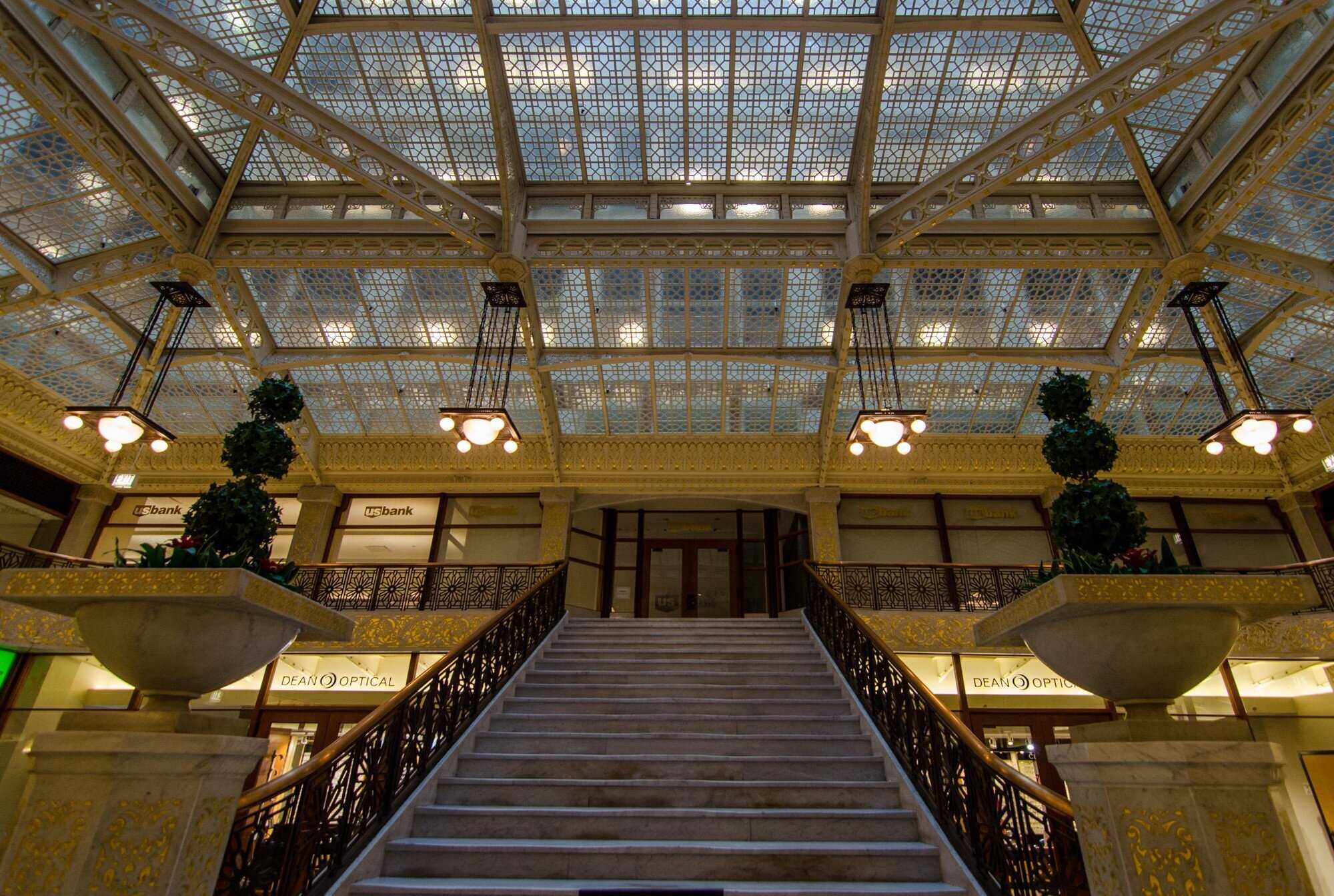 view looking down a staircase with black ornate railings