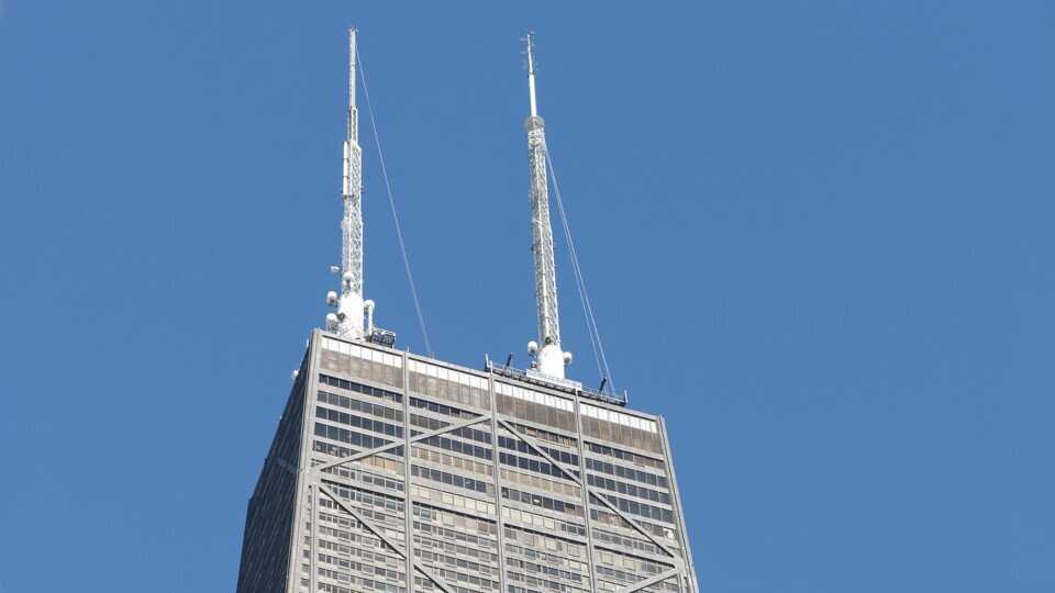 Two large antennae atop a tall building