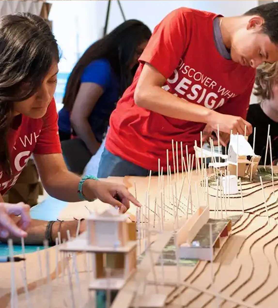 Two teens with red t-shirts working on a building project