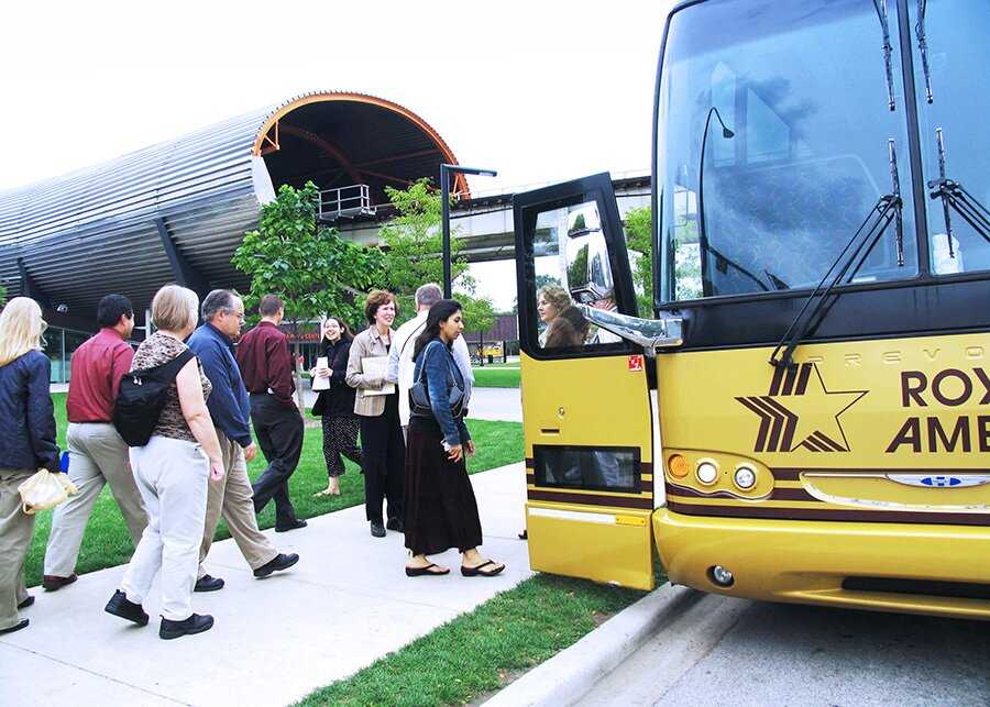 Group of tourists getting ready to board a tour bus