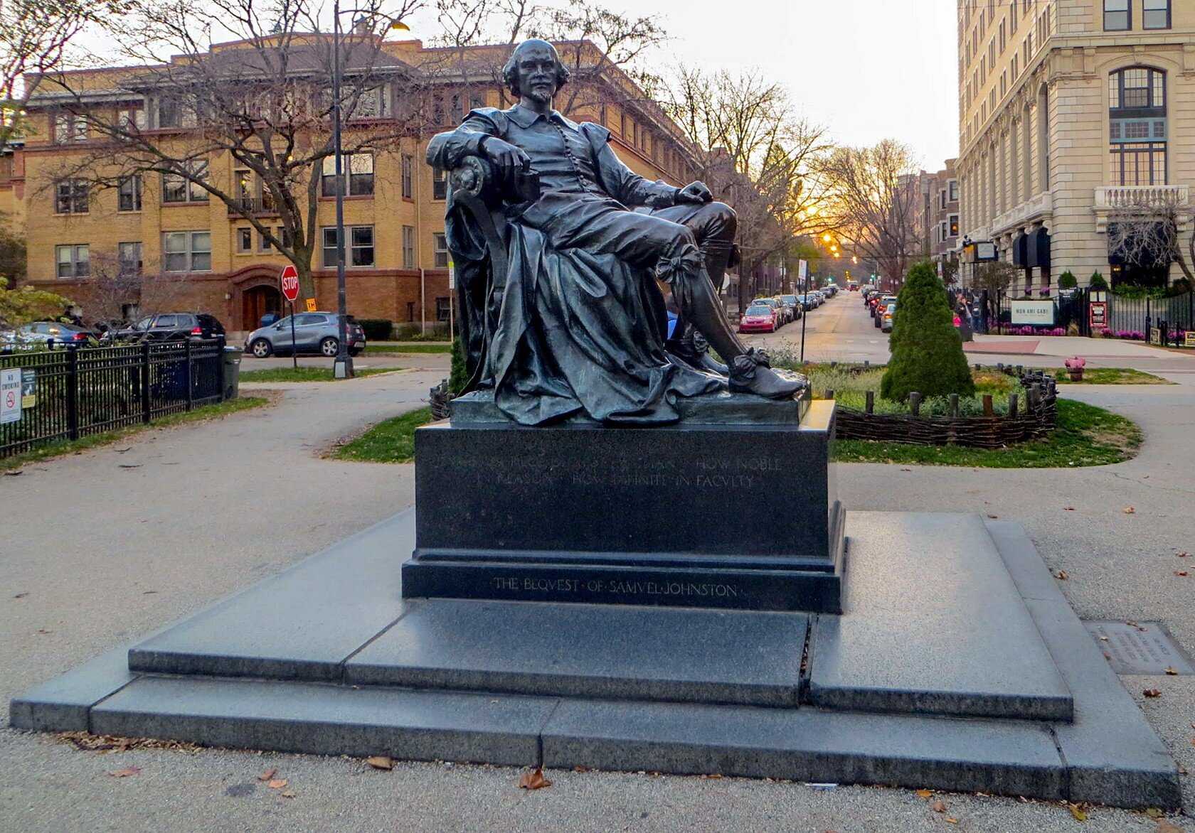 A photo of a statue of a seated Shakespeare