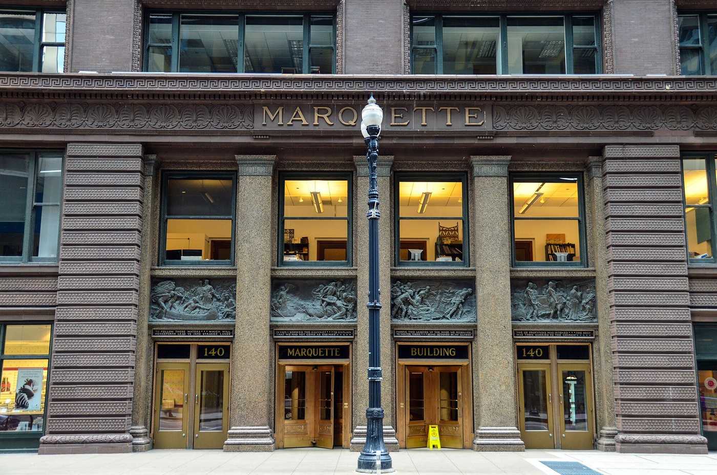 Exterior of brown building with three columns