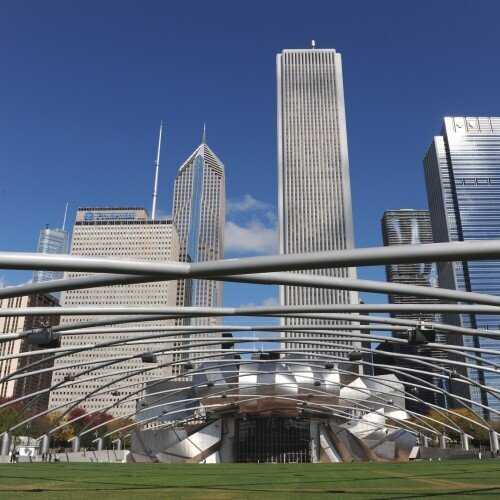 looking up at chicago skyscrapers from view of pritzker pavilion