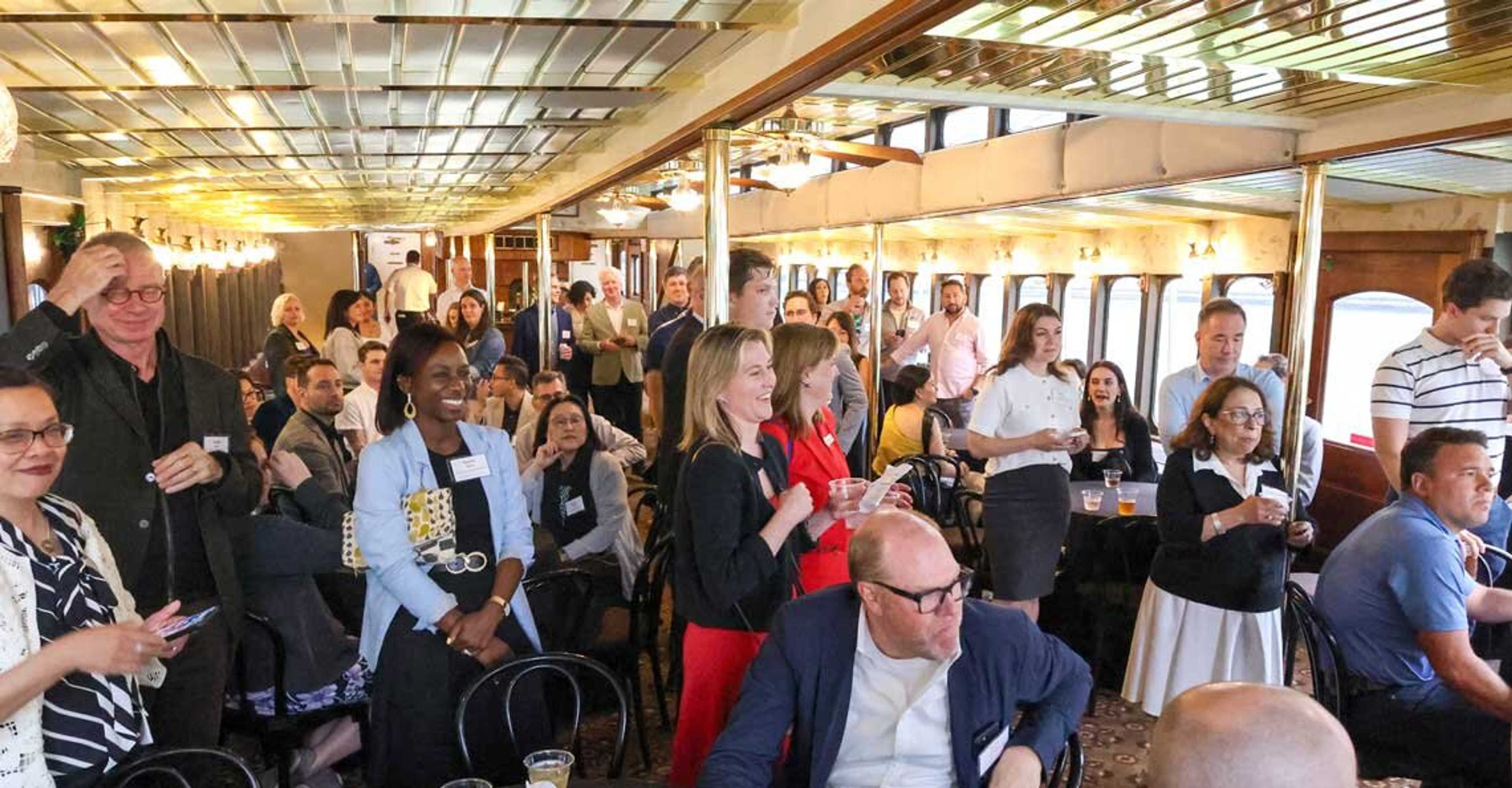 Interior of a cruise with professionals standing around and smiling