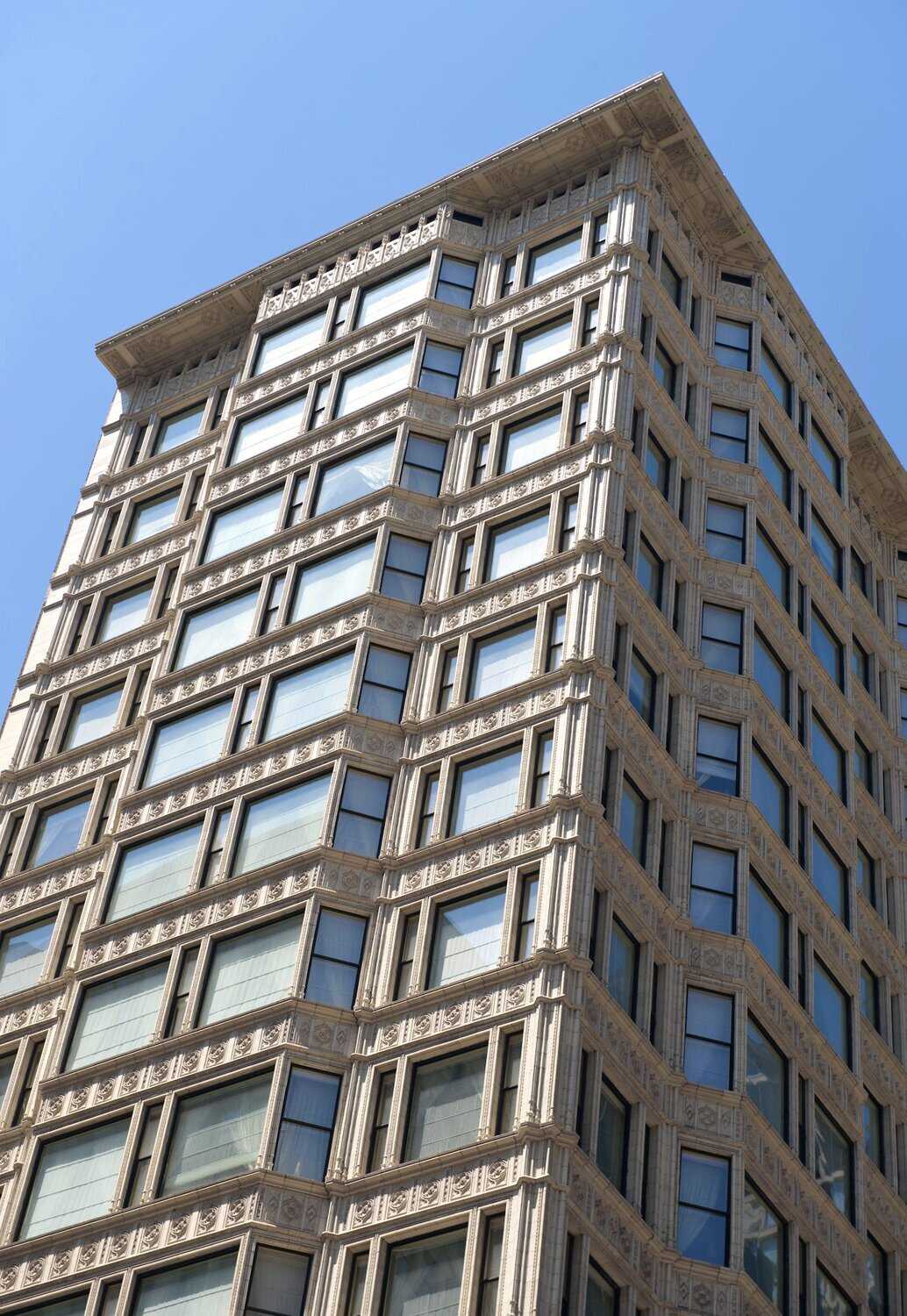 Exterior of white building with large windows