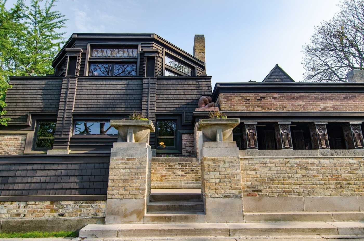 Frank Lloyd Wright Home and Studio exterior, showcasing Prairie School architecture with horizontal lines, overhanging eaves, and natural materials.