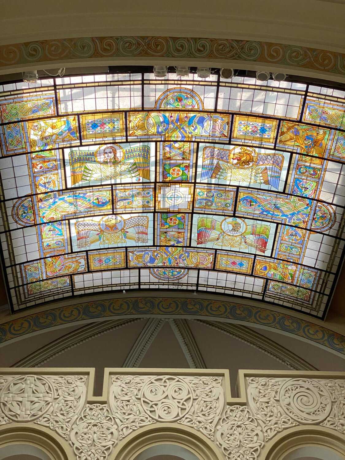 Interior shot of a stain glass ceiling of an old church