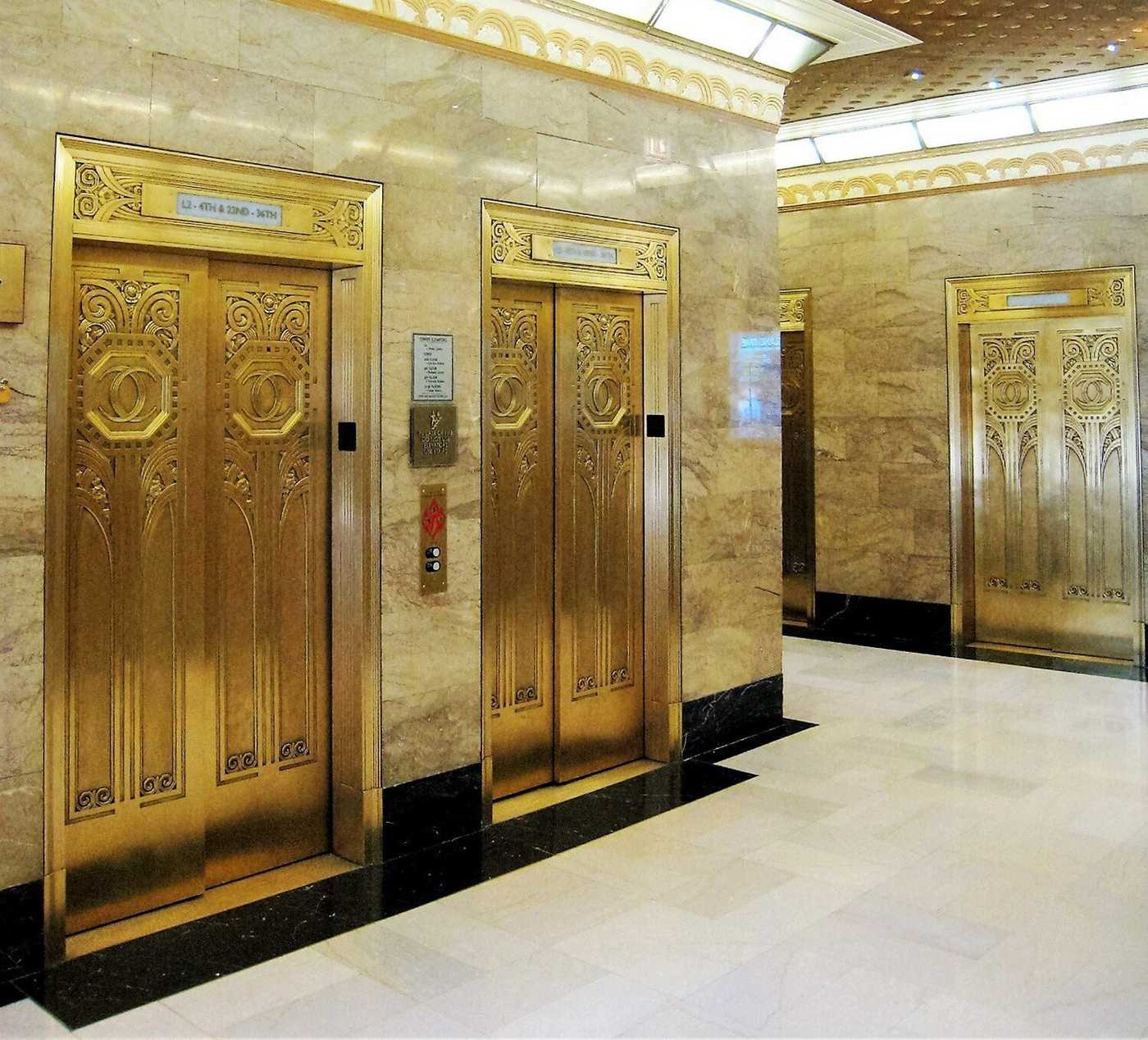 Ornate golden elevator doors in building lobby