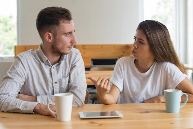 Why do men pull away after getting close — emotional couple photo showing woman feeling confused and man distant in silence.