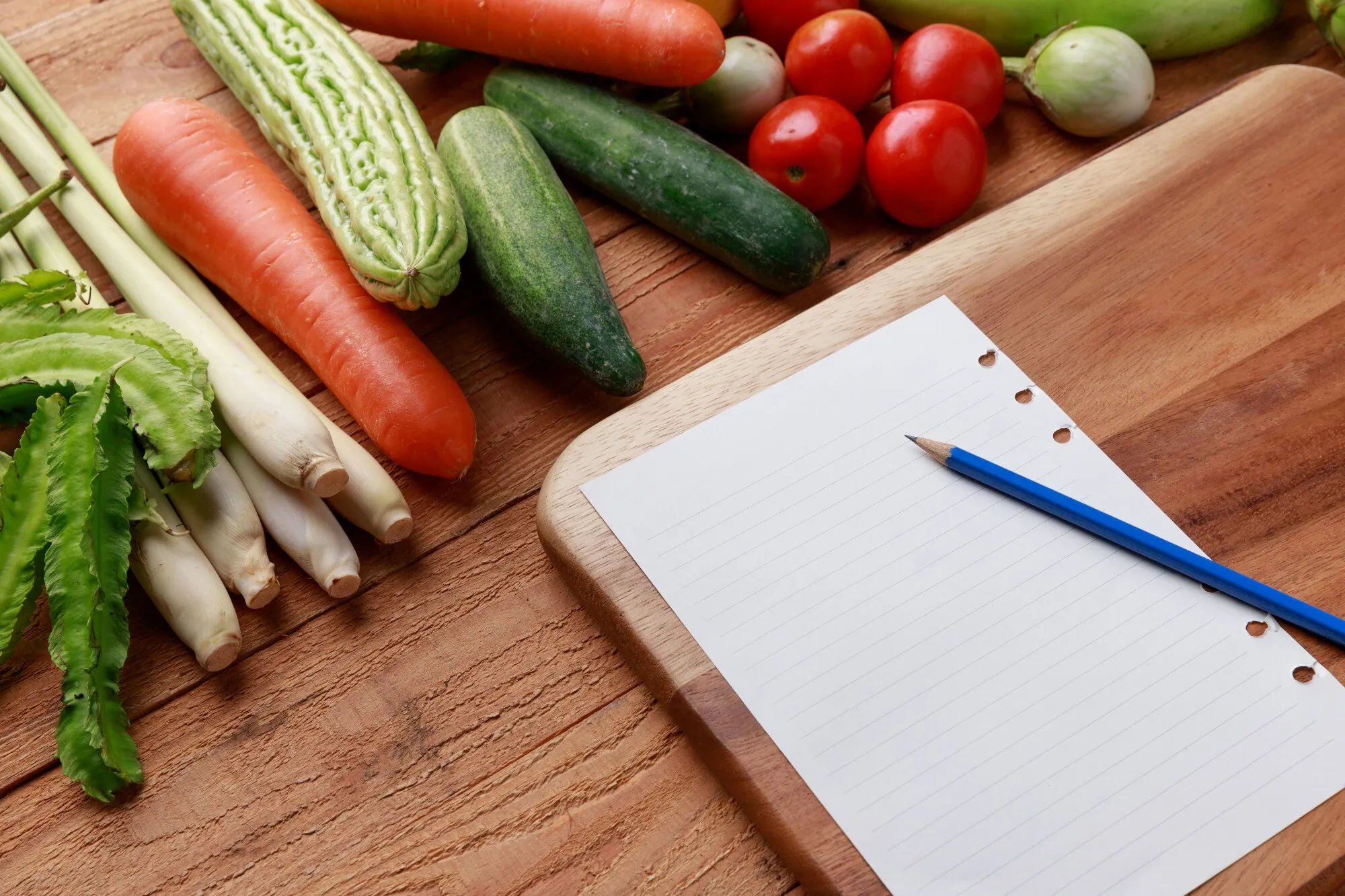 Blank pantry inventory sheet beside vegetables and a pencil
