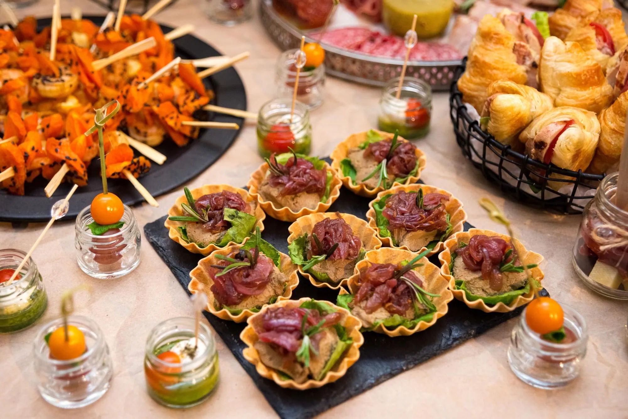 Assorted tartlets, skewers and finger foods on a party buffet