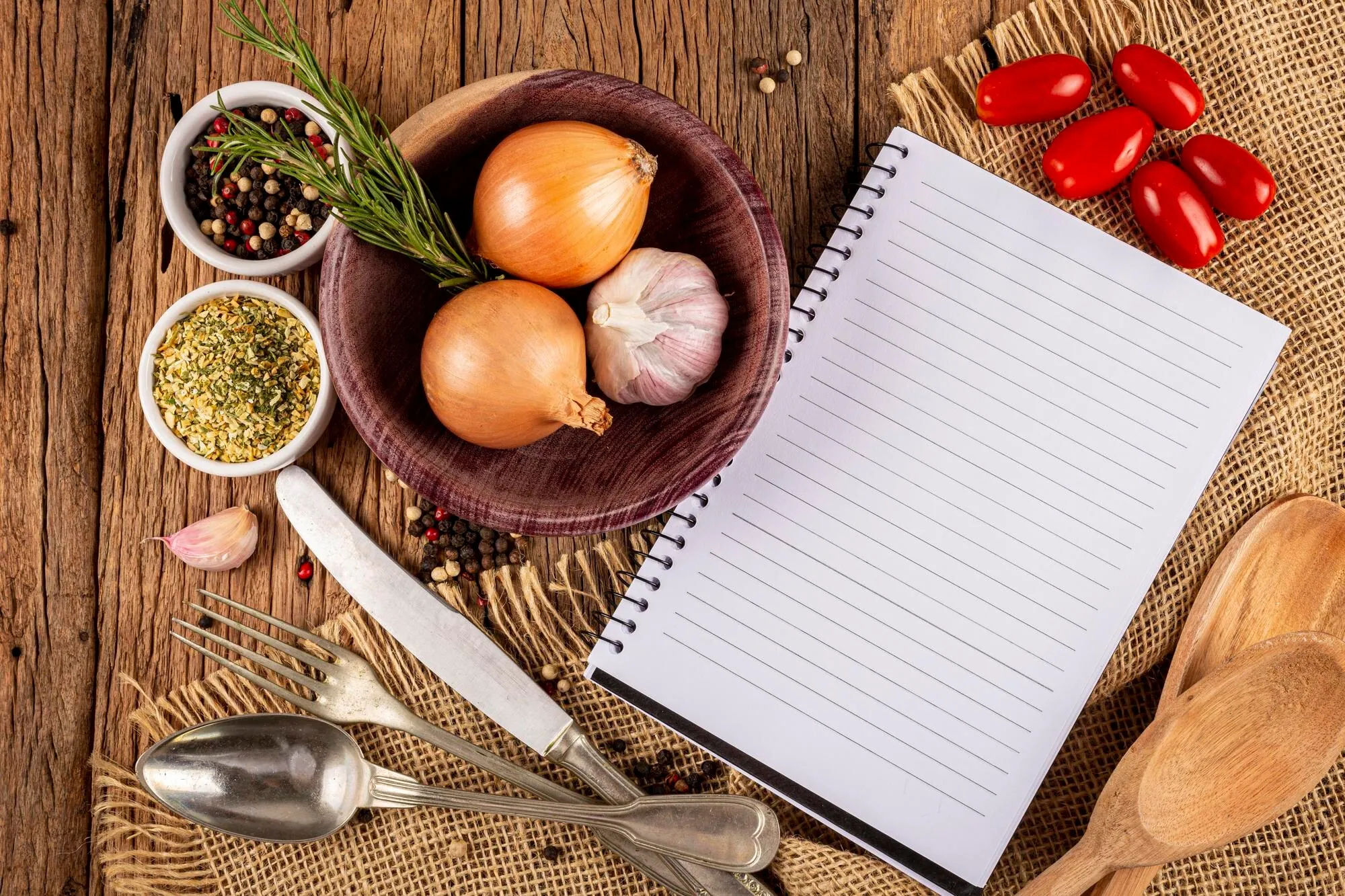 Recipe notebook and ingredients on a kitchen table