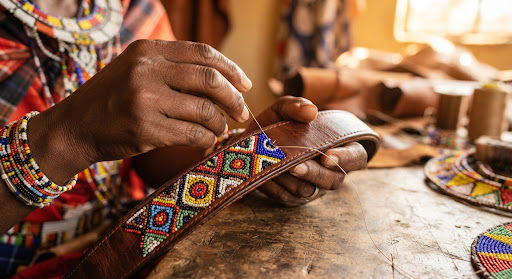 Artisan hands beading a leather collar