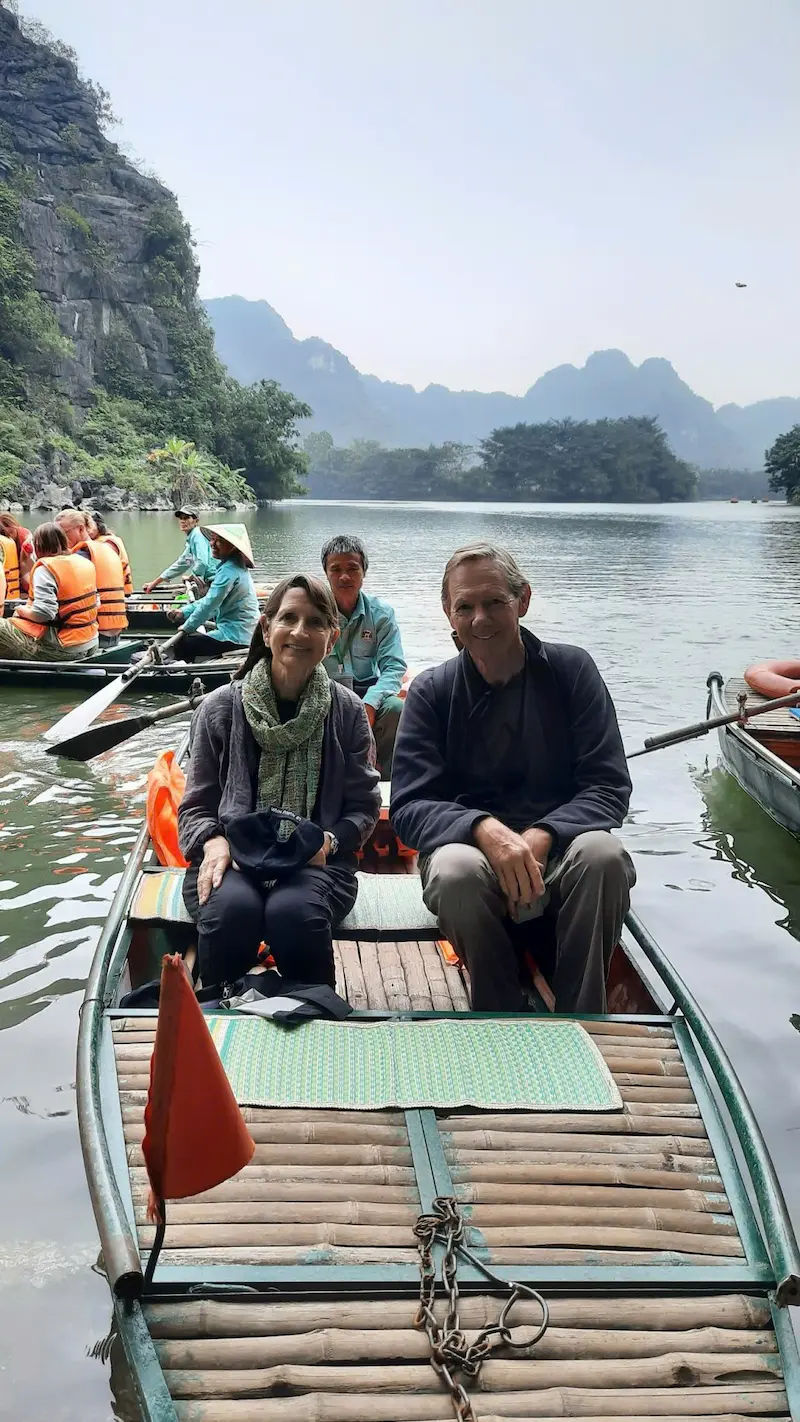 two senior travelers on a boat tour in Ninh Binh vietnam