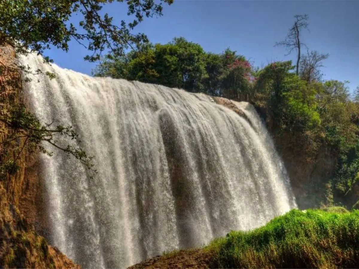 Elephant Waterfalls is a waterfall in the Central Highlands of Vietnam. It is located about 25 km from Da Lat on the Cam Ly River. A path with steps carved out into the slippery rocks leads to the foot of the falls. Bats roam around the area, where they inhabit a cave under the waterfalls.