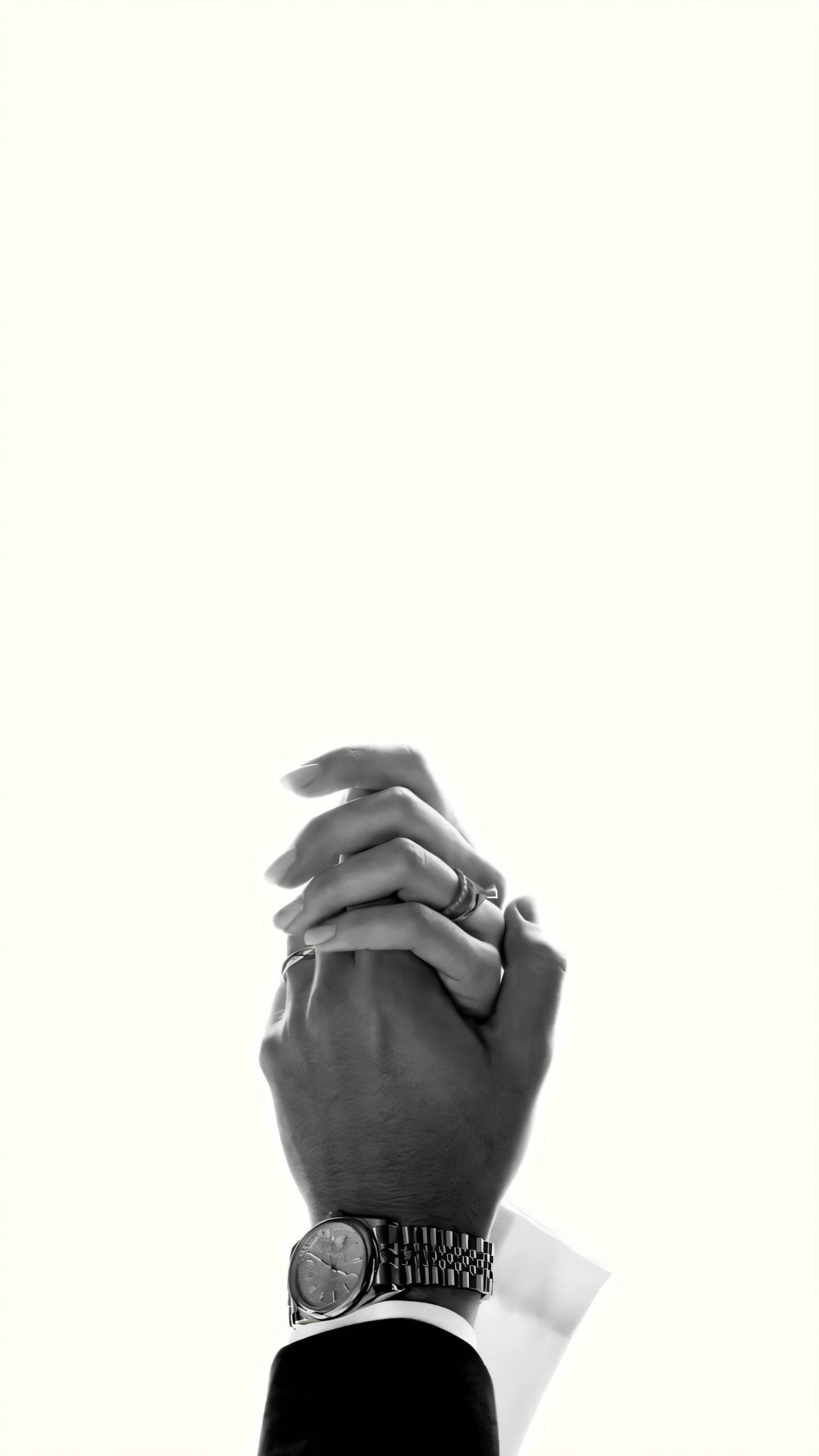 Mary and Paul's hands clasped together, her engagement and wedding rings on her finger.