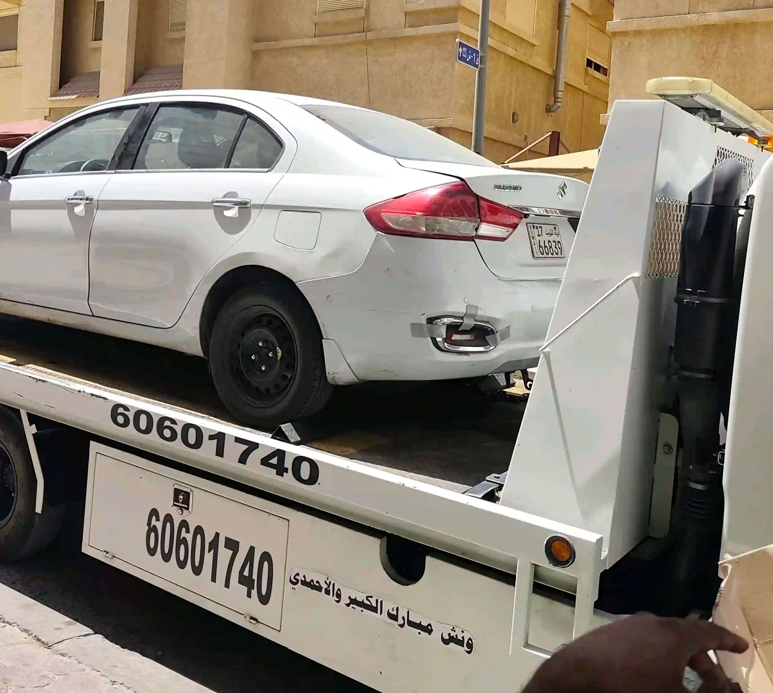 Hydraulic flatbed transporting a car in Kuwait