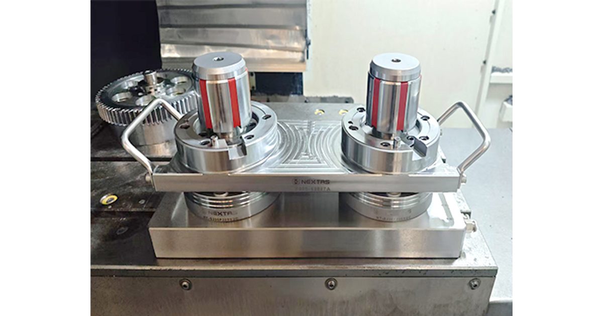 Two cylindrical workpieces on a dual-station fixture mounted to round receivers in a machine