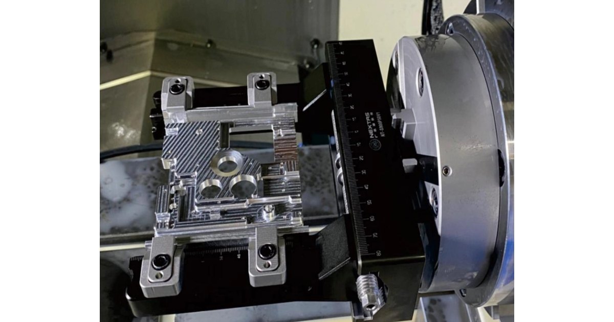Blue window-shape dovetail fixture mounted on a blue pneumatic zero-point plate with four round receivers