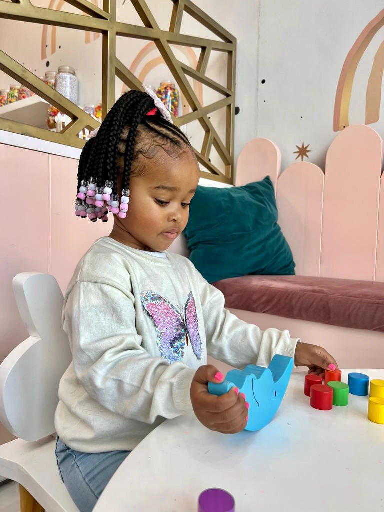 Elegant children's hairstyling in progress by our skilled and creative team