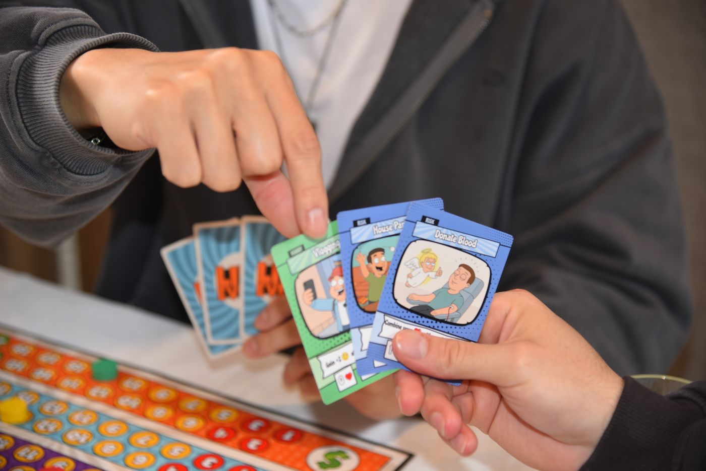 Two players comparing Career Path cards across the table