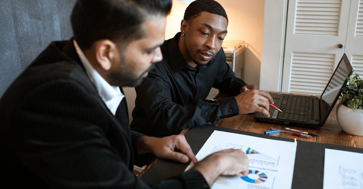 Two people reviewing a resume with charts.