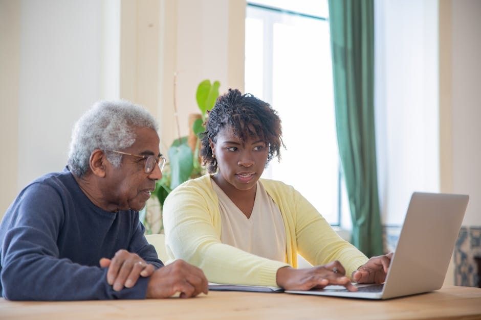 Image of a man and a woman working on a laptop