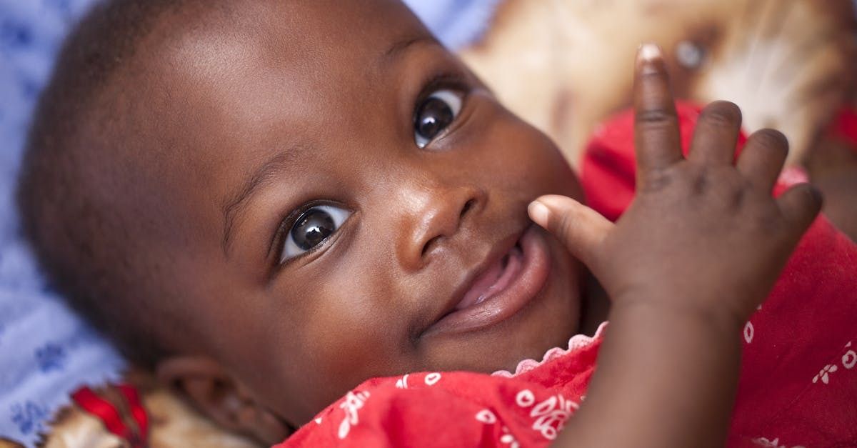 a happy baby wearing a red shirt