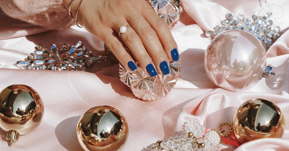 Image of beautiful blue fingernails in a holiday setting.